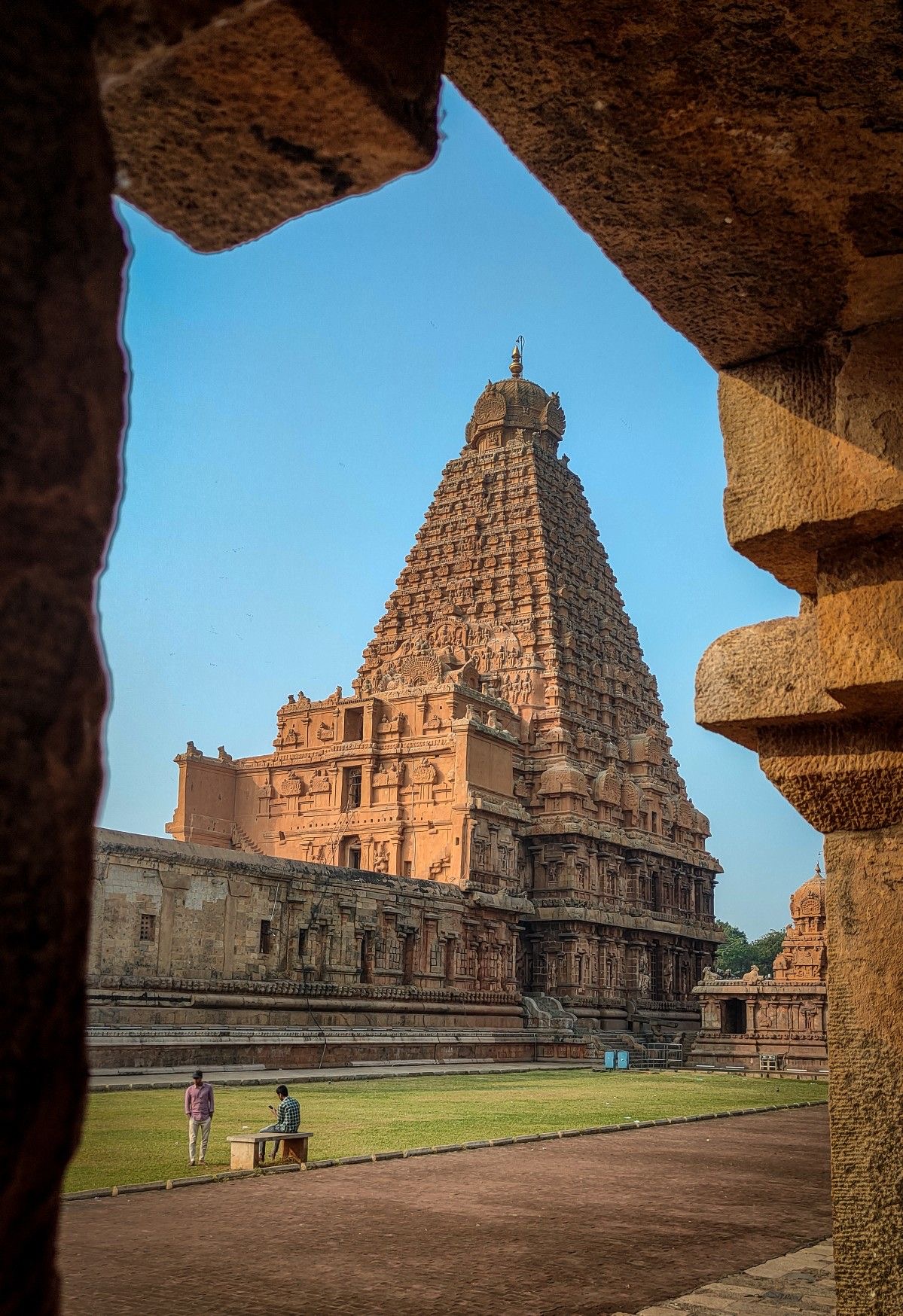 Ancient Dravidian temple tower framed by stone.